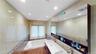 Bathroom featuring a built-in tub, dual sink vanity with chrome fixtures, and a large wall-mounted mirror