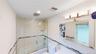 Bathroom featuring a glass-enclosed tub-shower combination, recessed lighting, and a vanity light fixture