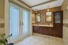 The primary bathroom has dual sinks and abundant cherry wood storage. The doors open out to the pool. No need to traipse water through the rest of the