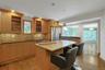 The eat-in island, spacious granite counters and abundant cabinet space should be seen in person to be truly appreciated. The kitchen opens to the din
