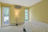 This third bedroom, with comfortable carpet underfoot, overlooks the pool.