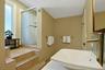 The full hall bathroom has, like so much of the rest of the home, been, thoroughly renovated. Across from the tile shower is a deep linen closet.