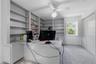 Upstairs bedroom currently being used as an office with built-in desk and cabinetry