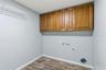 Inside Laundry room with storage and door to garage