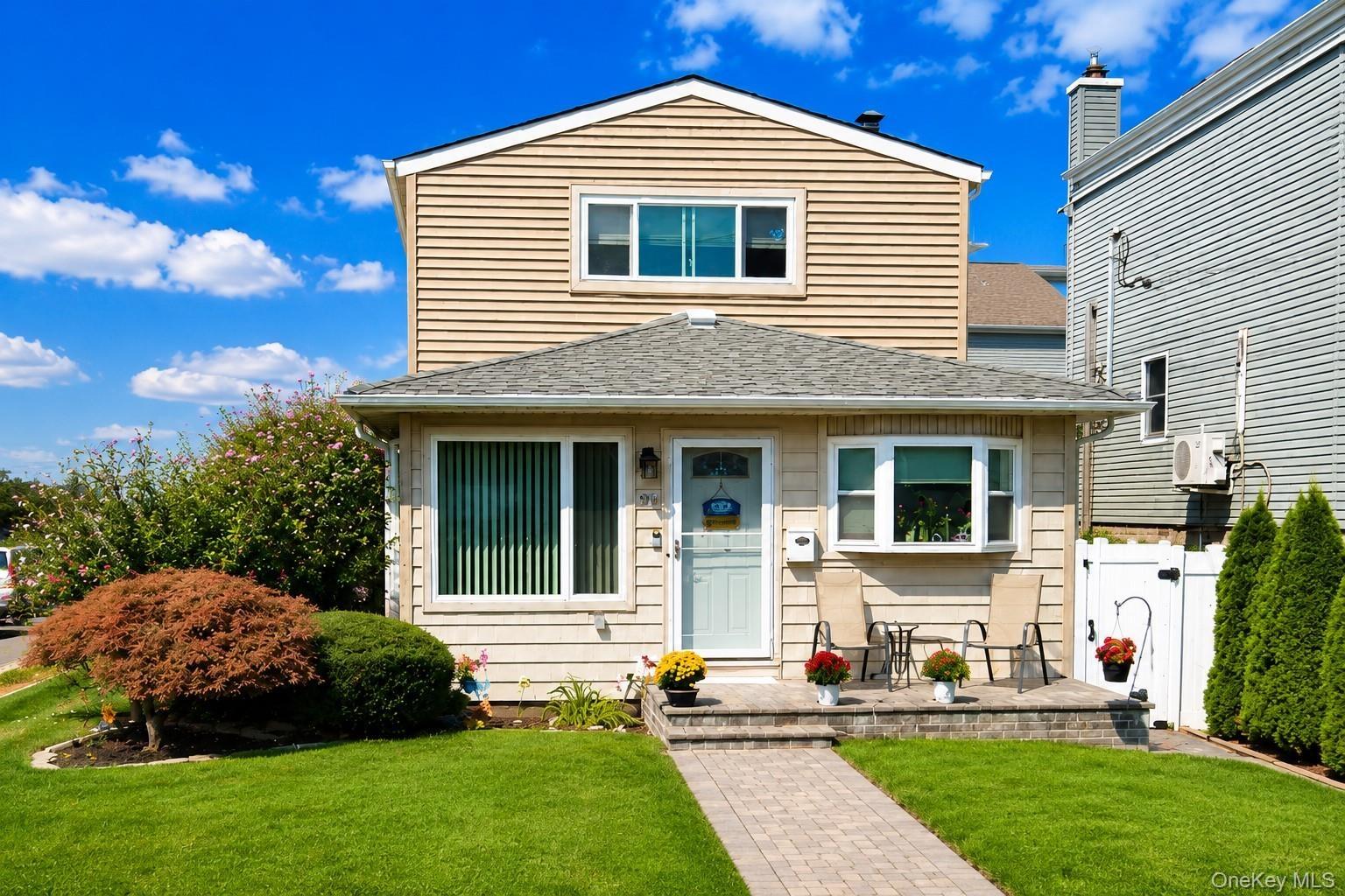 Colonial featuring light-toned horizontal siding and a gabled roof