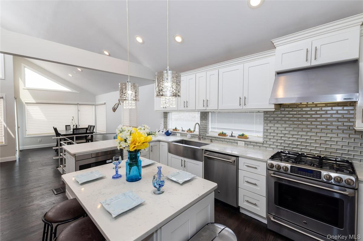 Contemporary kitchen featuring white cabinetry and stainless-steel appliances