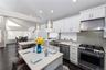 Contemporary kitchen featuring white cabinetry and stainless-steel appliances