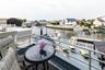 Waterfront deck featuring a gray finish, aluminum railings, and direct water access with multiple docks