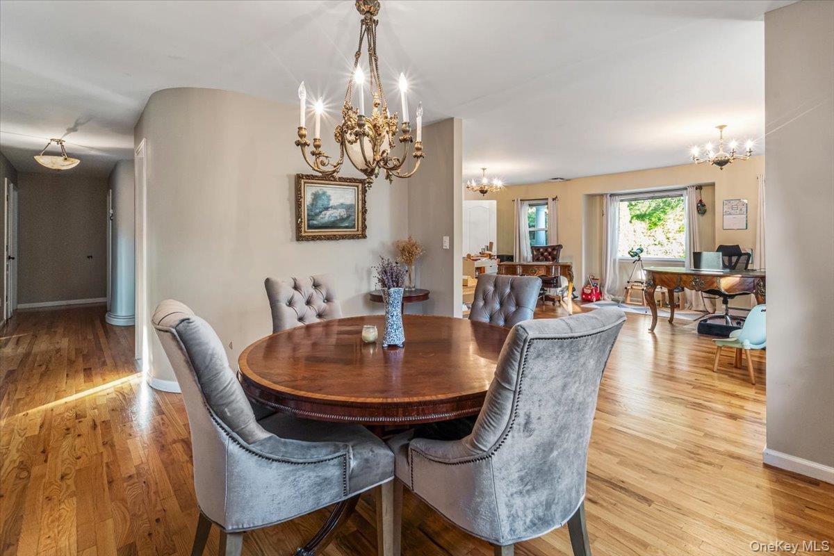 Hardwood flooring extending throughout the dining area and into the hallway