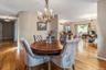 Hardwood flooring extending throughout the dining area and into the hallway