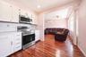 Kitchen featuring white cabinetry, stainless steel microwave, and a stainless steel electric range