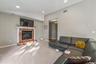 Living area featuring a fireplace with a stone-finish surround and white mantel, recessed lighting, carpet flooring, and a wall-mounted television