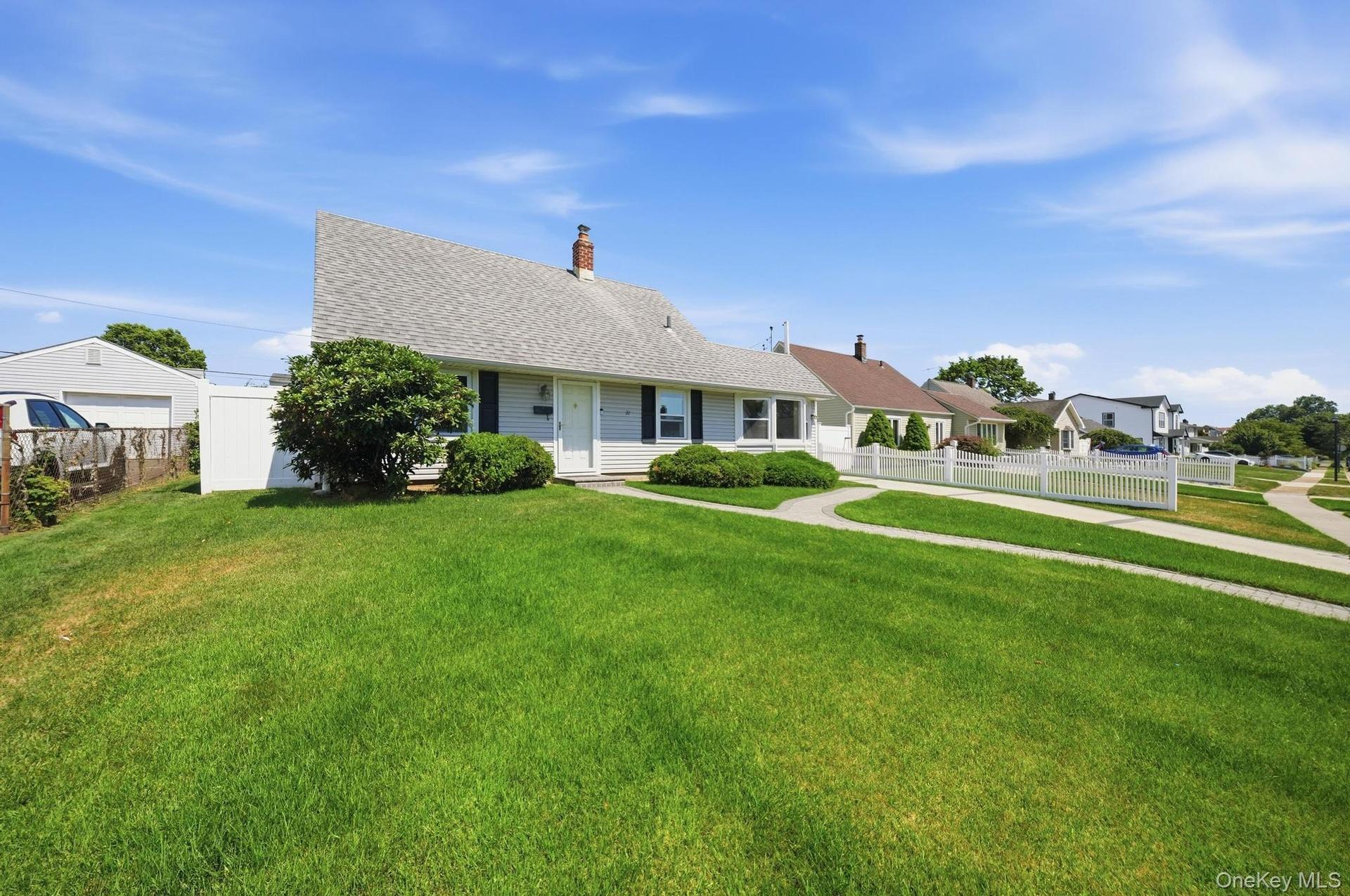 Single-story home featuring a gray shingle roof, light-colored siding, and dark shutters