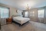 Expansive room with neutral carpeting and light-toned walls