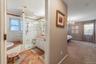 Well-appointed bathroom featuring a glass-enclosed shower, a built-in tub with tile surround, a vanity with under-sink cabinetry, and a window