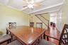 Dining area with rich wood-finish flooring and a wood ceiling fan