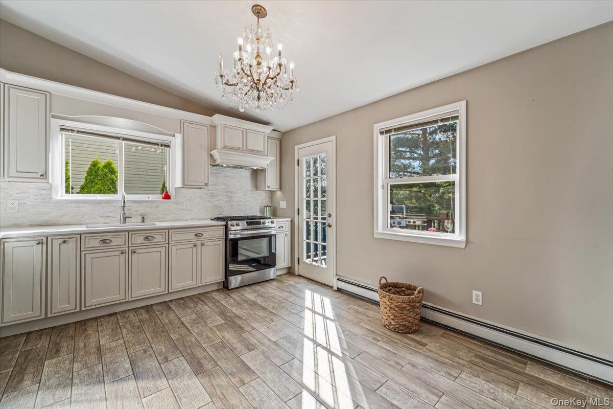 Kitchen featuring light wood-finish flooring and a crystal chandelier
