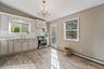 Kitchen featuring light wood-finish flooring and a crystal chandelier