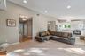 Expansive living area with recessed lighting and neutral wall tones