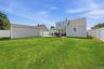 Expansive green lawn with a privacy fence