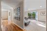 Living area featuring light-toned carpeting and recessed lighting