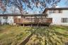 Rear view of property with a wooden deck and a yard