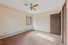 Unfurnished bedroom with a baseboard radiator, carpet floors, and ceiling fan