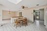 kitchen with a skylight, a baseboard radiator, and ceiling fan