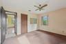 Unfurnished bedroom featuring carpet flooring, a closet, a baseboard heating unit, and ceiling fan