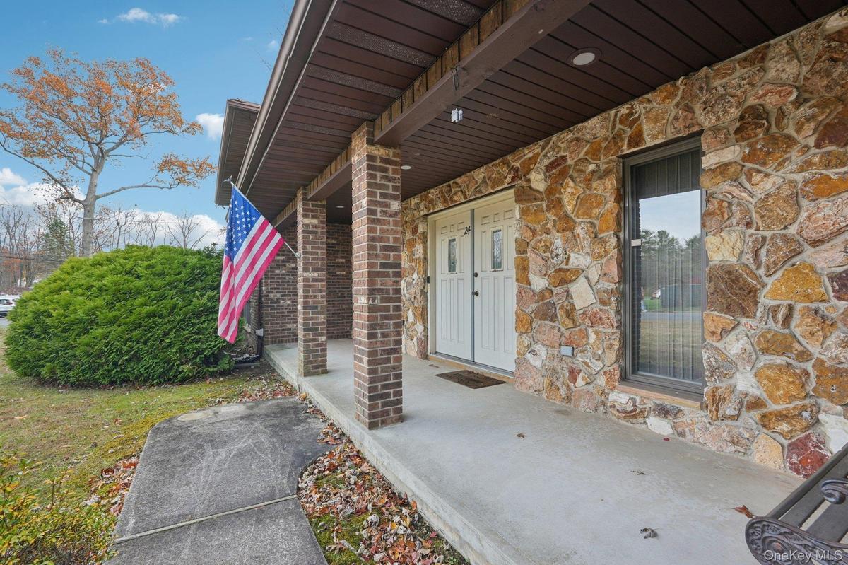 Property entrance featuring stone siding