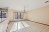 Spare room featuring baseboard heating, a chandelier, and light tile patterned flooring