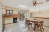 Kitchen featuring a skylight, black appliances, light countertops, and plenty of natural light