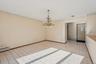 Unfurnished room with light tile patterned floors, a chandelier, and a baseboard heating unit