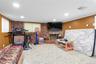 Playroom featuring crown molding, a baseboard radiator, brick wall, and recessed lighting