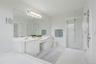 Primary Bathroom boasts separate shower, large soaking tub, double vanity and light tiles