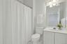 Main level full bath, with tub and lights tiles