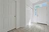 Spacious foyer, tiled floors, leads to oversized 2-car garage