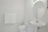 Guest half bath with light fixtures and tiles