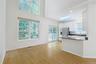 Bright kitchen with light cabinetry, peninsula and lots of windows. Access to private patio