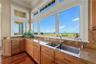 Washing dishes may become the best seat in the house, with sweeping ocean and golf course views stretching far beyond the sink.