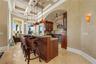 The kind of gathering place where guests naturally linger long after dinner,  while the wet bar keeps refreshments within easy reach.