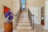 The staircase is accented by custom solid bronze railings, selected not only for their beauty but also for their durability and ability to withstand t