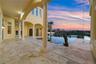 Covered lanai with travertine flooring.
