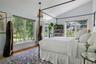 Vaulted ceiling with dual-aspect windows overlooking the gardens