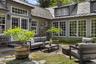 A beautifully landscaped stone courtyard, offering a secluded outdoor setting for entertaining and quiet relaxation