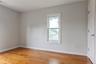 Hardwood-finish flooring enhancing a light-filled upstairs bedroom