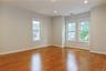 Spacious bedroom featuring wood-finish flooring, recessed lighting, and multiple windows