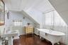 Charming upstairs bathroom with classic clawfoot soaking tub
