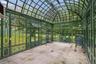 Imported Hartley Botanic greenhouse from England, creating an elegant glass pavilion for year-round growing, entertaining, or quiet retreat
