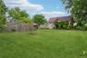 Expansive green lawn with mature trees